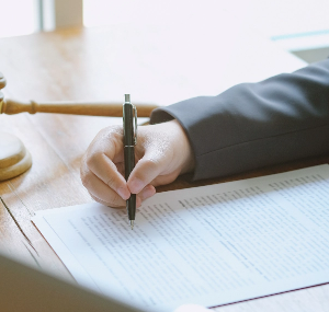 cropped-hands-man-writing-paper-desk